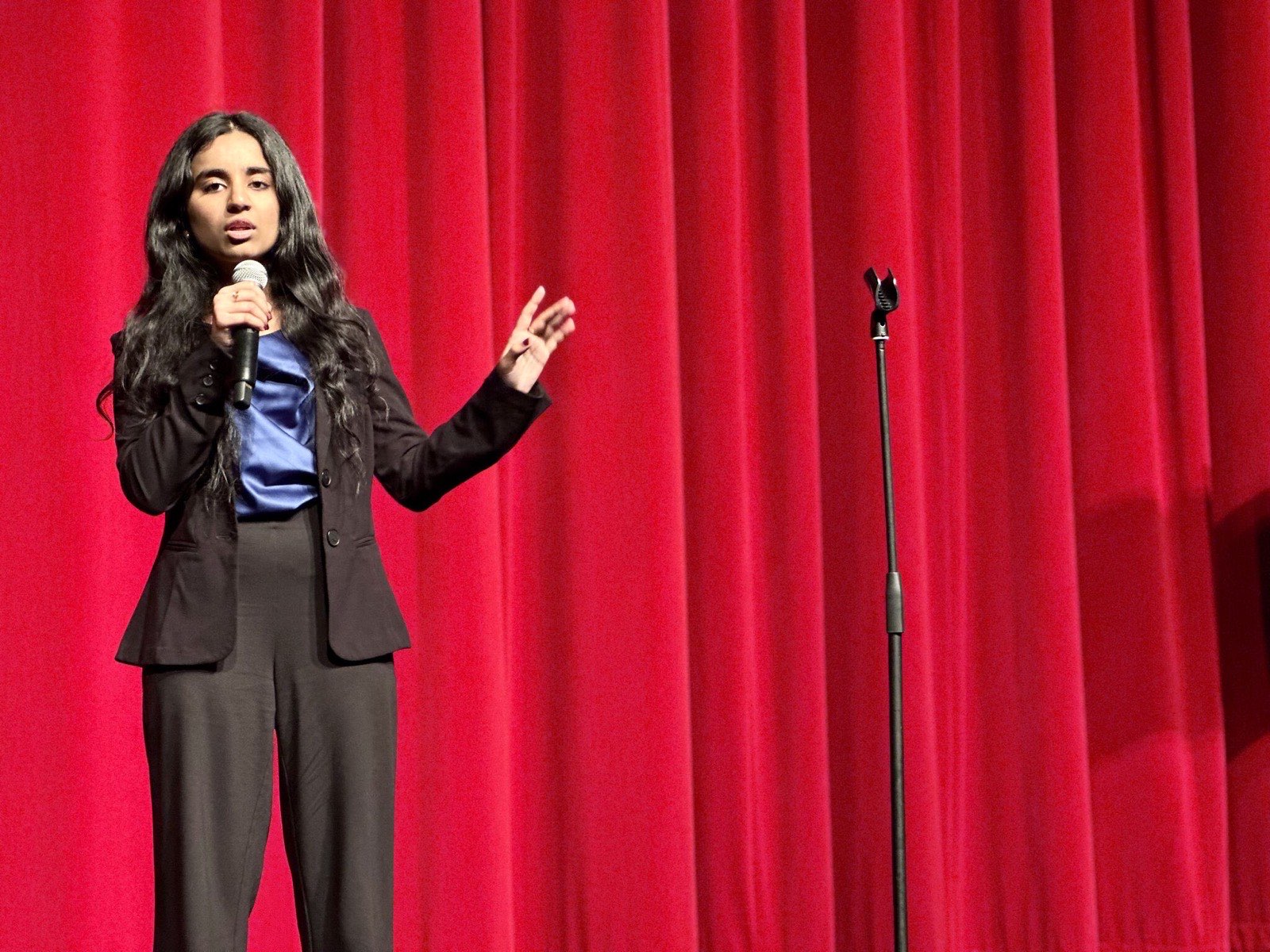 Rutu Ruparel speaking on stage at the TEDx event